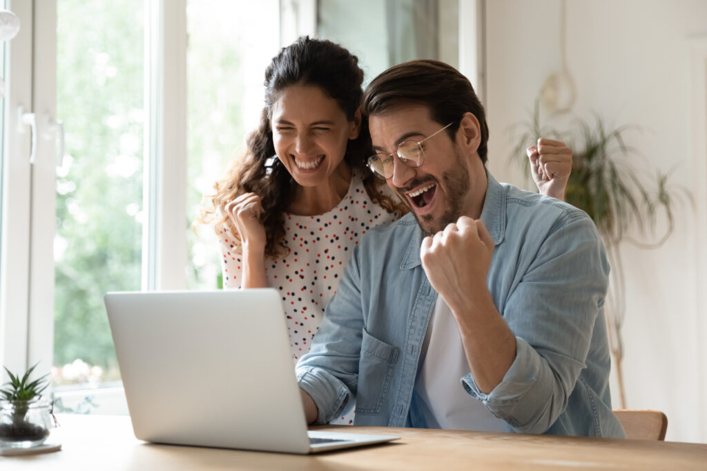 overjoyed,millennial,man,and,woman,triumph,win,online,lottery,on