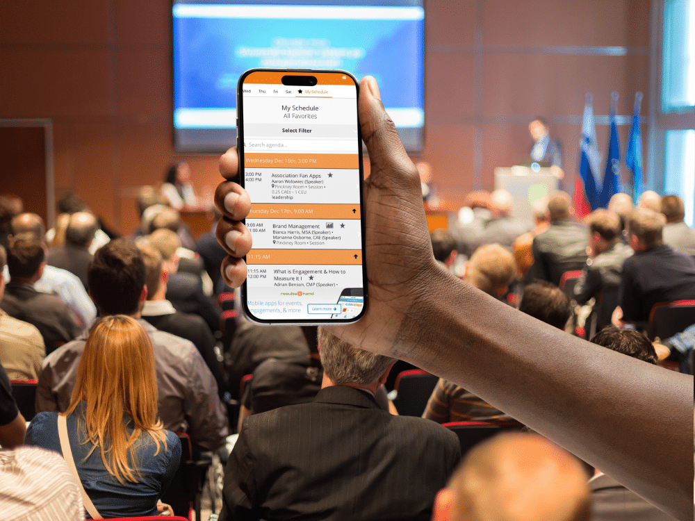 Attendee using a mobile event app during a meeting